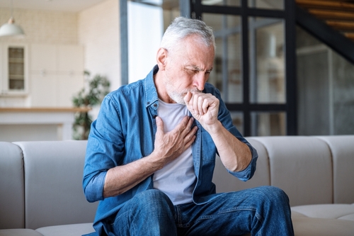 Elderly man experiencing morning cough caused by asthma